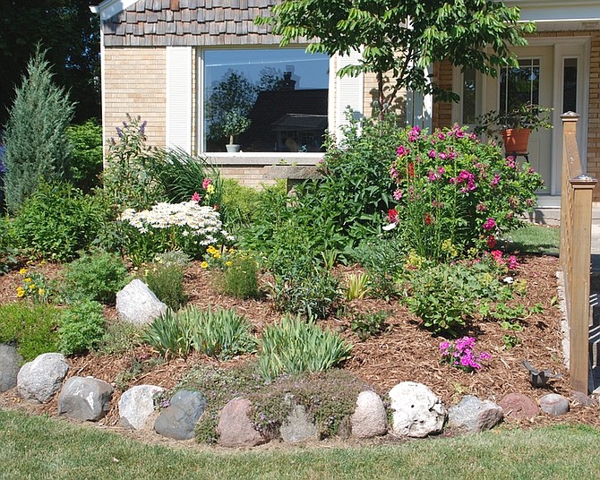 File PhotoThe rules of landscaping design include balance side-to-side, planting taller plants in back, and blending color and texture. Good design helps home buyers feel at home.