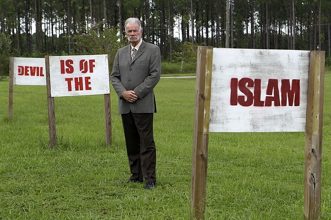 In this photo taken Monday, Aug. 30, 2010,  Rev. Terry Jones poses for a photo at the Dove World Outreach Center in Gainesville, Fla. Jones vowed to go ahead with plans to burn copies of the Quran to protest the Sept. 11 terrorist attacks despite warnings from the White House and the top U.S. general in Afghanistan that doing so would endanger American troops overseas. (AP Photo/John Raoux)