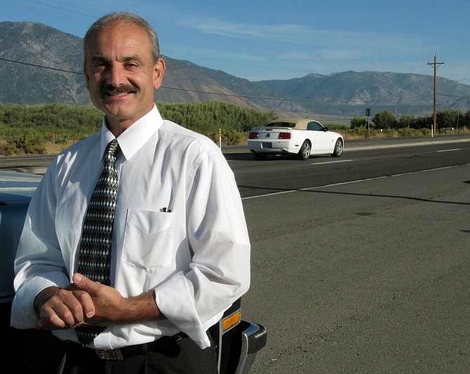 In this Aug. 31, 2010 photo, Eugene &quot;Gino&quot; DiSimone, a nonpartisan Nevada gubernatorial candidate, stands along U.S. 395 south of Carson City, Nev. DiSimone, one of seven candidates for governor on the Nov. 2 general election ballot, estimates the Silver State could rake in $1 billion a year or more with his speeding plan, and that&#039;s just one of several not necessarily conventional proposals DiSimone thinks will turn Nevada around. (AP Photo/Sandra Chereb)