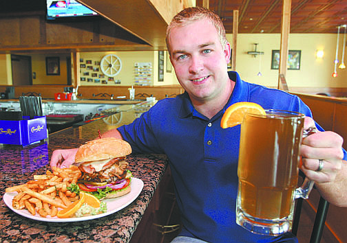 Jim Grant/Nevada AppealJustin Schmidt, co-owner of Canyon Creek Grill and Bar displays a couple of menu items.