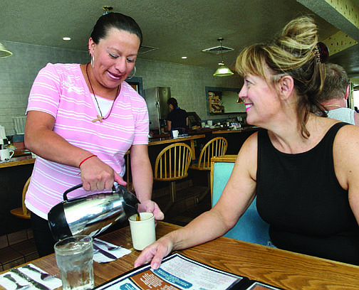 Jim Grant/Nevada AppealJazmin Rodriguez, a waitress at Grandma Hattie&#039;s, serves a cup of coffee to customer Marilyn Harber on Monday morning.