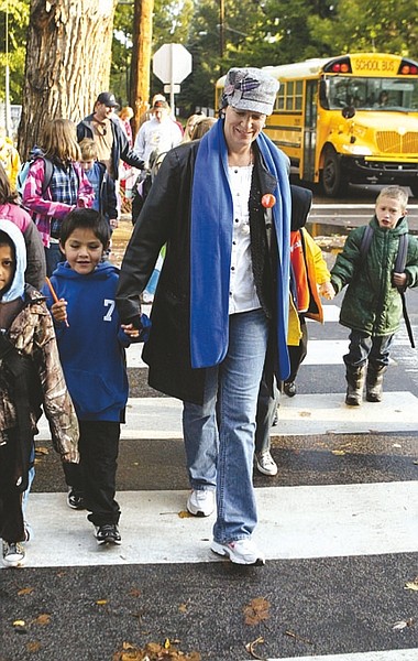 Shannon Litz/Nevada AppealSusan Squires of Bordewich-Bray Elementary School walks down Mountain Street with first-grader Michael Putt, 6, on Wednesday during Walk to School Day. Squires was joined by more than 20 students and Carson City Mayor Bob Crowell.
