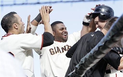 San Francisco Giants&#039; Buster Posey, top right, is congratulated by Andres Torres, left, Pablo Sandoval, center, and Freddy Sanchez after hitting a solo home run off of San Diego Padres&#039; Luke Gregerson in the eighth inning of a baseball game in San Francisco, Sunday, Oct. 3, 2010. (AP Photo/Jeff Chiu)