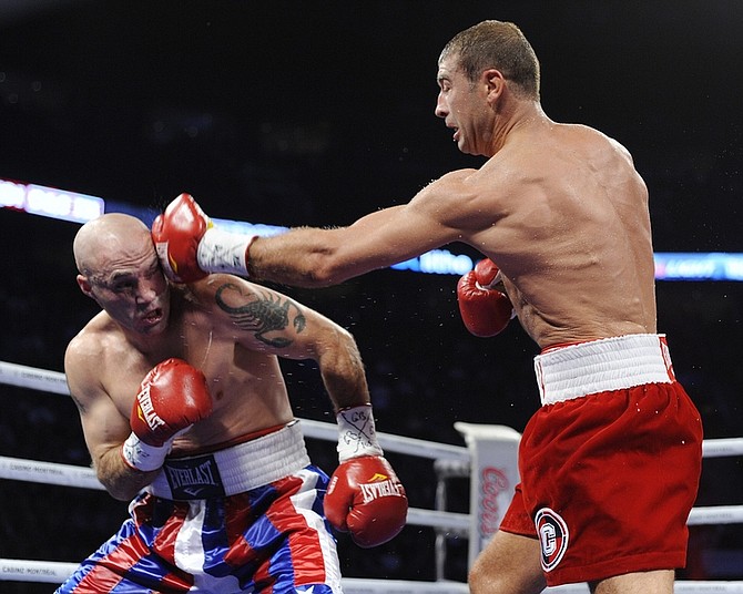Lucian Bute from Montreal, Canada, right, lands a blow to the head of Jesse Brinkley, from the United States, during their IBF super middleweight title bout in Montreal on Friday Oct. 15, 2010. (AP Photo/The Canadian Press, Graham Hughes)