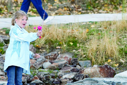 Seven-year-old Zenobia Pitts casts her line at the Carson City Urban Fishing Pond on Saturday during Kids Fishing Day. About 100 people showed up for the pond dedication.