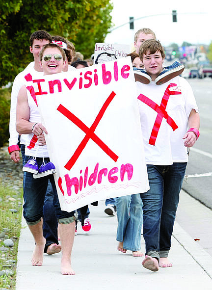 Shannon Litz/Nevada AppealCarson High School students walk north on Carson Street on Friday evening as part of the Invisible Children walk.