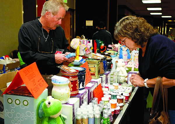 Photos by Shannon Litz/Nevada AppealErnie Magee tells Dayton resident Angie Parsley about Scentsy Flameless Candles at the  crafts fair. The event benefits Court Appointed Special Advocates.