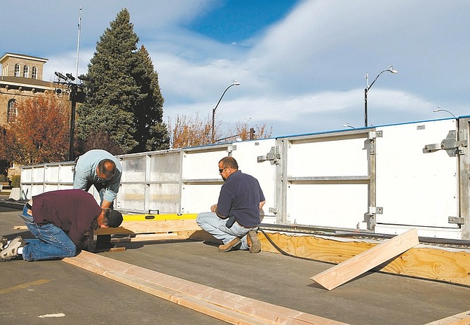 Photos by Shannon Litz/Nevada AppealPaul Dininger, Dick Buttner and Ron Reed work on the Carson City ice rink on Thursday.