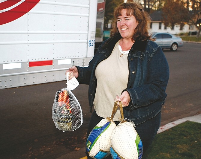 Shannon Litz/Nevada AppealDayton resident Sheryl Landers drops off three turkeys at Mike&#039;s Pharmacy on Wednesday.