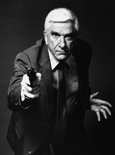 FILE - This 1988 file photo provided by Paramount, shows actor Leslie Nielsen as Lt. Frank Drebin in the movie &quot;The Naked Gun: From the Files of Police Squad!&quot; The Canadian-born Nielsen, who went from drama to inspired bumbling as a hapless doctor in &quot;Airplane!&quot; and the accident-prone detective Frank Drebin in &quot;The Naked Gun&quot; comedies, has died. He was 84. His agent John S. Kelly said the actor died Sunday, Nov. 28, 2010, at a hospital near his home in Florida where he was being treated for pneumonia. (AP Photo/Paramount, File)