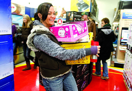 Shannon Litz/Nevada AppealChristy Gray of Dayton heads for the checkout line at Best Buy early Friday morning. She said she was in line at 4:45 a.m. and she came for a Wii and a boom box and got both.