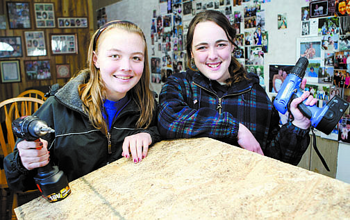 Shannon Litz/Nevada AppealThirteen-year-old Lexi Reid and 12-year-old Delaney Mott, both Cadet Girl Scouts, work on their cat condos Wednesday to help the Carson Tahoe Society for the Prevention of Cruelty to Animals feral cat colonies around Carson City.
