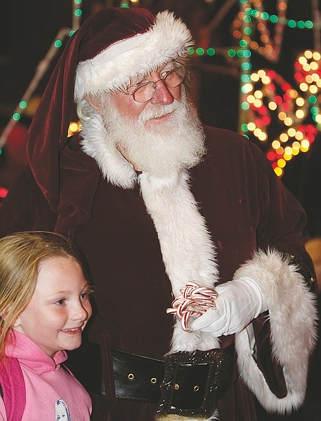 Shannon Litz/Nevada AppealSix-year-old Ariana Rohrer has her picture taken with Santa Claus at the Laxalt Plaza on Thursday during the Silver &amp; Snowflakes event.