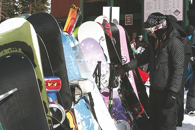Adam Jensen/Nevada Appeal News ServiceA visitor to Sierra-at-Tahoe Ski Resort retrieves her snowboard last week.