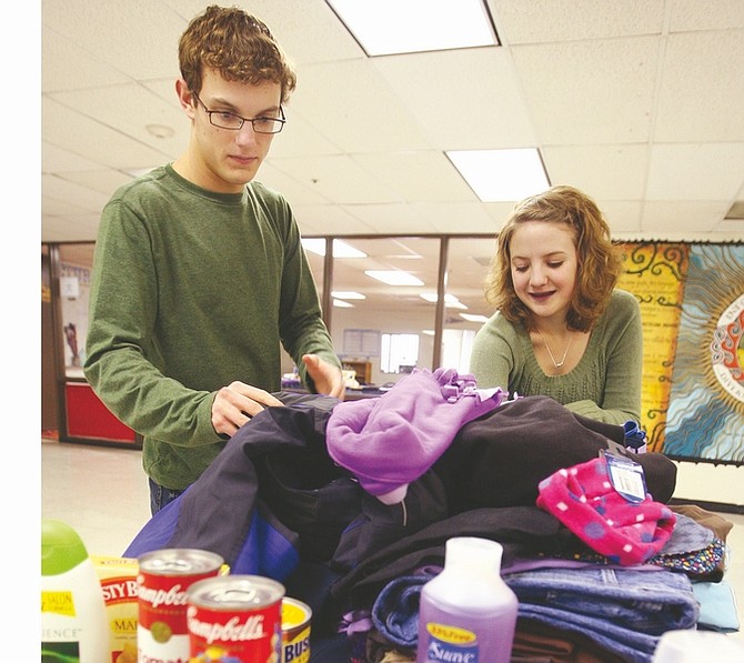 Jim Grant/Nevada AppealCarson High School junior class president Tim Grunert, left, and freshman class president Mariah Whitcome sort through donated clothes, food and beauty products that were collected during the school&#039;s Giving Week last week.