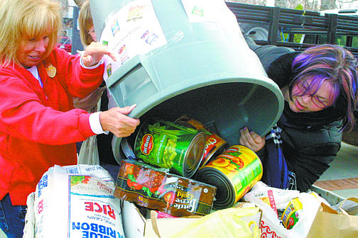 Sandi Hoover/ Nevada AppealVolunteers for Advocates to End Domestic Violence empty a barrel of donated food into one of the bins at the Governor&#039;s Mansion Friday during the 18th annual Share Your Holiday Food Drive.