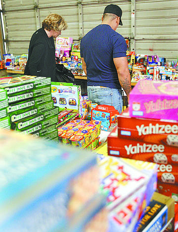 Jim Grant/Nevada AppealVolunteer Michelle Pacheco, left, helps a Carson City man pick out Christmas presents at the Toys for Joy program on Tuesday afternoon.