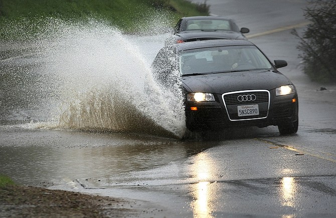 Vehicles dodge mud and standing water on Mulholland Highway near Skyline Drive as heavy rain continued to fall most of the day in Los Angeles, Sunday, Dec. 9 2010. (AP Photo/Los Angeles Times, Brian van der Brug) MANDATORY CREDIT; MAGS OUT; NO SALES; NO FOREIGN; TELEVISION OUT; INTERNET OUT; LOS ANGELES DAILY NEWS OUT; ORANGE COUNTY REGISTER OUT; VENTURA COUNTY STAR OUT; INLAND VALLEY DAILY BULLETIN OUT; SAN BERNARDINO SUN OUT; LA OPINION OUT.