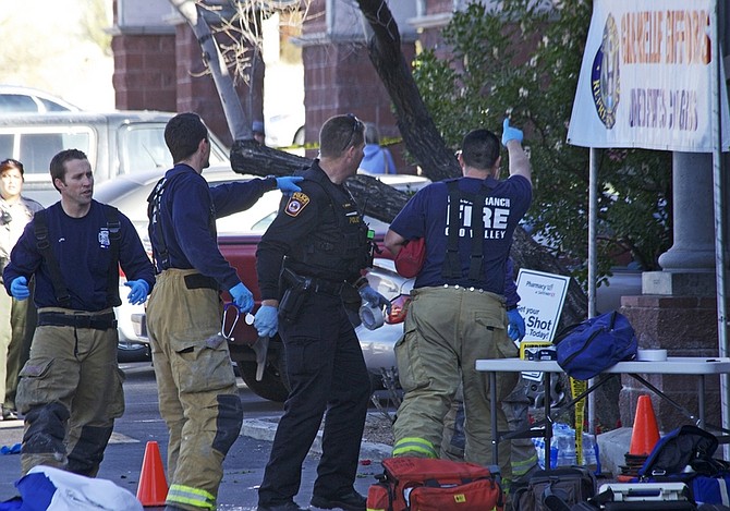 Emergency personnel set up outside the  shopping center in Tucson, Ariz. on Saturday, Jan. 8, 2011 where U.S. Rep. Gabrielle Giffords, D-Ariz., and others were shot as the congresswoman was meeting with constituents.  (AP Photo/James Palka)