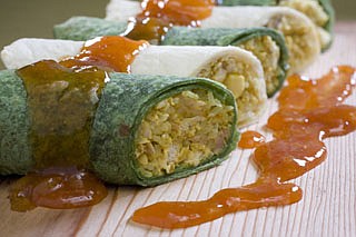 This Oct. 5, 2010 photo shows curried chicken and rice burritos. Put the taste of India into a classic Mexican dish with this burrito recipe. Consider a mango chutney or salsa as a condiment.    (AP Photo/Larry Crowe)