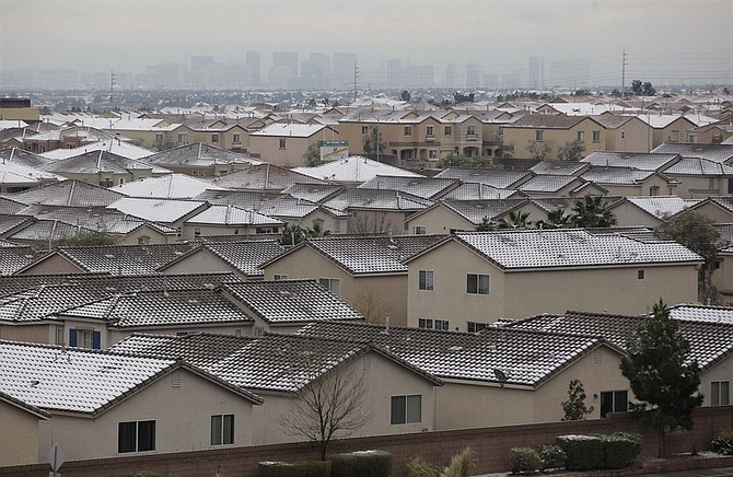 A thin layer of snow sits on rooftops west of The Strip, Monday, Jan. 3, 2011 in Las Vegas, Nev. Between one and two inches of snow fell on the west side of town. (AP Photo/Julie Jacobson)