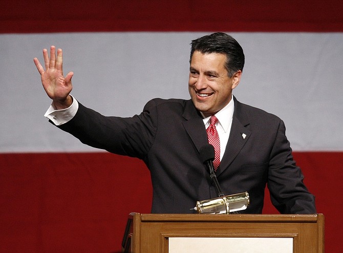 FILE - In this Nov. 2, 2010 file photo, Republican candidate for governor Brian Sandoval celebrates his victory over Democratic opponent Rory Reid at an election-night party, in Las Vegas. Twenty-six states elected new governors last month _ 17 Republicans, 8 Democrats and one independent _ and now they are going to have to reconcile their principles and campaign promises with some harsh fiscal realities. In Nevada, with a projected deficit of $1.1 billion to $3 billion, Sandoval is refusing to raise taxes, calling it &quot;the worst thing you could do&quot; during a recession. Nevada leads the nation in home foreclosures and bankruptcies and has the highest employment rate at 14.2 percent. (AP Photo/Julie Jacobson, File)