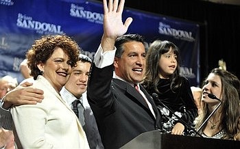 Republican Nevada gubernatorial candidate Brian Sandoval celebrates his victory with his family at an election night party Tuesday, Nov. 2, 2010, in Las Vegas. From left, Kathleen Sandoval, son James, Brian Sandoval holding daughter Marisa, daughter Madeline. (AP Photo/Mark Damon)