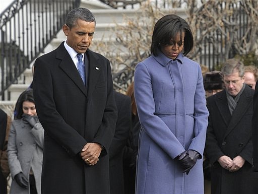 President Barack Obama, first lady Michelle Obama and government employees observe a moment of silence on South Lawn of the White House in Washington, Monday, Jan. 10, 2011, to honor those who were killed and injured in the shooting in Tucson, Ariz. Rep. Gabrielle Giffords, D-Ariz., is in critical condition after being shot in the head. (AP Photo/Susan Walsh)