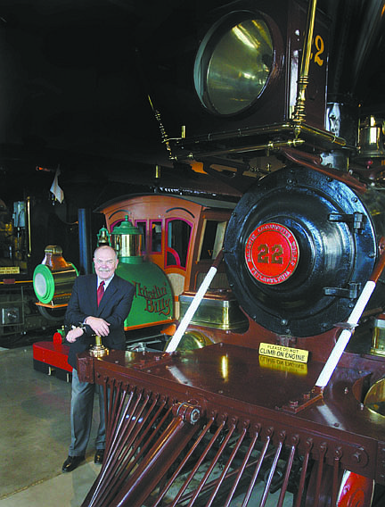 Jim Grant/Nevada AppealMike Fischer, director of Nevada Department of Cultural Affairs poses next to the restored V&amp;T locomotive, Inyo, that is on display at the Nevada State Railroad Museum.