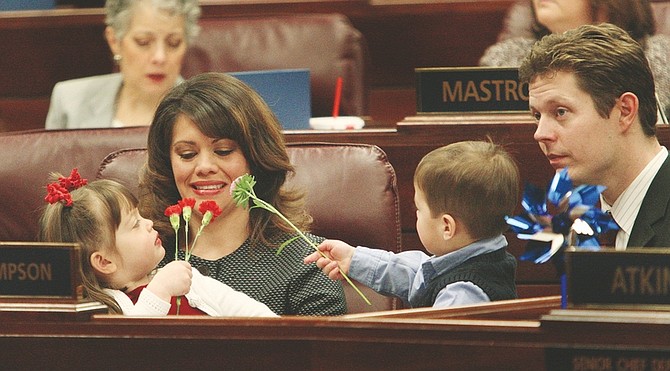 Jim Grant/Nevada AppealAssembly member Teresa Benitez-Thompson enjoys a moment in the Assembly chamber with her husband Jeff and daughter Lillian, 3, and son Eli, 2, on Monday.