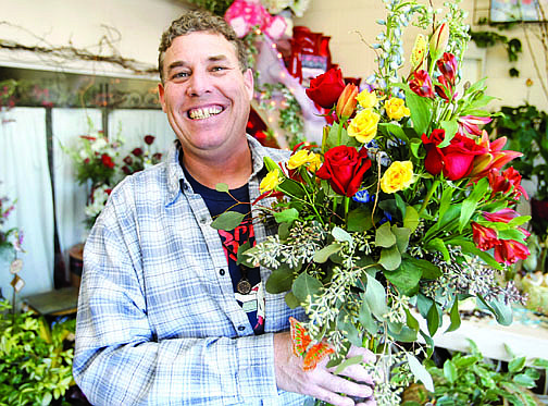 Shannon Litz/Nevada AppealTom Jones, owner of Carson City Florist, with an arrangement of roses, lilies, delphinium and eucalyptus at the shop on Wednesday.