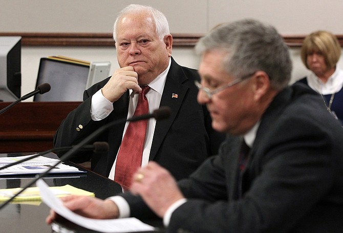 Nevada Assemblyman Pete Livermore, R-Carson City, left, listens as Bruce Kittess testifies in favor of Livermore&#039;s proposal to allow municipalities to put aesthetic restrictions on residential green energy devices during a hearing at the Legislature in Carson City, Nev. on Monday, Feb. 28, 2011. (AP Photo/Cathleen Allison)