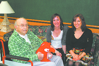 Abagail Scott, center, and Rachael Lambin pose Feb. 6 while chatting with veteran ???? and Evergreen Carson City. The pair  were part of a group of 15 who put on a musical show for the residents of home. &quot;It was wonderful and we had great times talking with the vets and hearing so many stories of their times overseas,&quot; Lambin said.