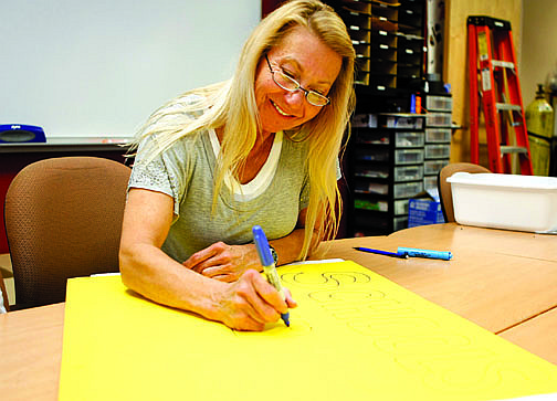 Shannon Litz/Nevada AppealWestern Nevada College student Lisa Light works on a poster that says, &quot;Schools or Fools&quot; on Thursday. WNC students will protest proposed budget cuts to the higher education system by Gov. Brian Sandoval at the Legislature on Monday.