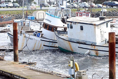Fishing boats crash into one another Friday, March, 11, 2011 in the boat basin at Crescent City, Calif., as one of a series of tsunami surges slams into the harbor, breaking up docks and tearing lose boats. An 8.9-magnitude earthquake in Japan sparked a tsunami that sped across the Pacific and caused tsunami warnings as far away as the west coast of the United States.  (AP Photo/Jeff Barnard)