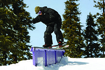 Published Caption: Pat Quinn, a Ralston team member, boardslides a down rail in the Alley at Sierra At Tahoe.