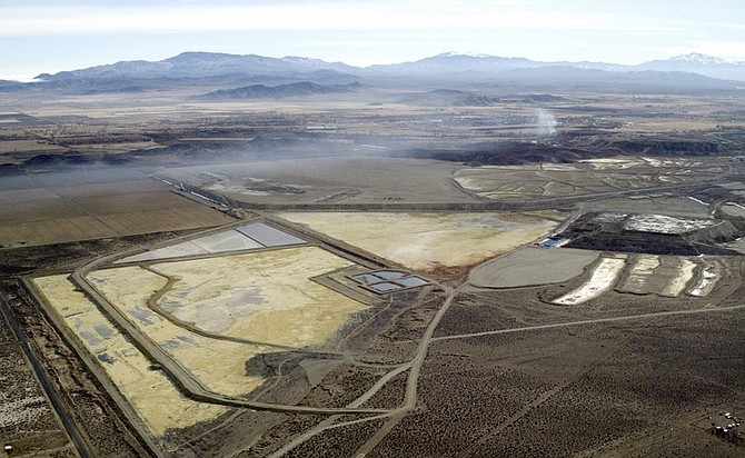 Published Caption: ** FILE ** Evaporation ponds at the Northeast end of an abandoned copper mine in Yerington, Nev., are shown in this aerial photograph taken Jan. 28, 2004. Under pressure from Sen. Harry Reid, D-Nev., and the Environmental Protection Agency, Gov. Kenny Guinn is signaling a new willingness to reconsider his opposition to declaring the abandoned mine a U.S. Superfund site.  (AP Photo/Cathleen Allison)