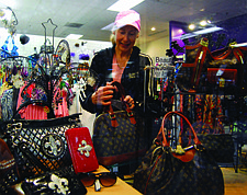 Brian Duggan/Nevada AppealSusan Shott, co-owner of Mama&#039;s Got A Brand New Bag in the Carson Mall, organizes her merchandise on Thursday.