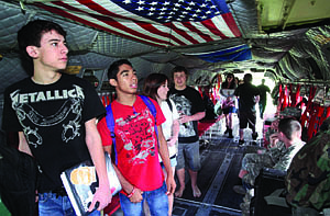 Carson High School seniors Justin Snowden, left, and Junior Estrada walk through the inside of a CH-47 Chinook helicopter that landed at the high school on Tuesday. The Nevada National Guard landed the Chinook on the front lawn of Carson High School so the students could look at it and talk to pilots.