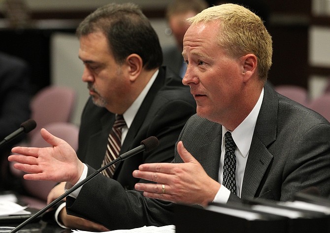 Clark County School District Chief Financial Officer Jeff Weiler, and banker Pat Zamora, left, tell lawmakers about the expected impacts of the governor&#039;s plan to take money from school bond reserve accounts to plug a budget hole during a hearing Tuesday, April 19, 2011, at the Legislature in Carson City, Nev. (AP Photo/Cathleen Allison)