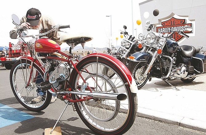 Shannon Litz/Nevada AppealLee Maehler of Carson City looks at a 1947 Whizzer bike at the Carson City Harley-Davidson car show &amp; shine on Saturday. Capital Classic Productions, organizer of the show and shine, has pledged 7,000 cans to The Food Bank of Northern Nevada.