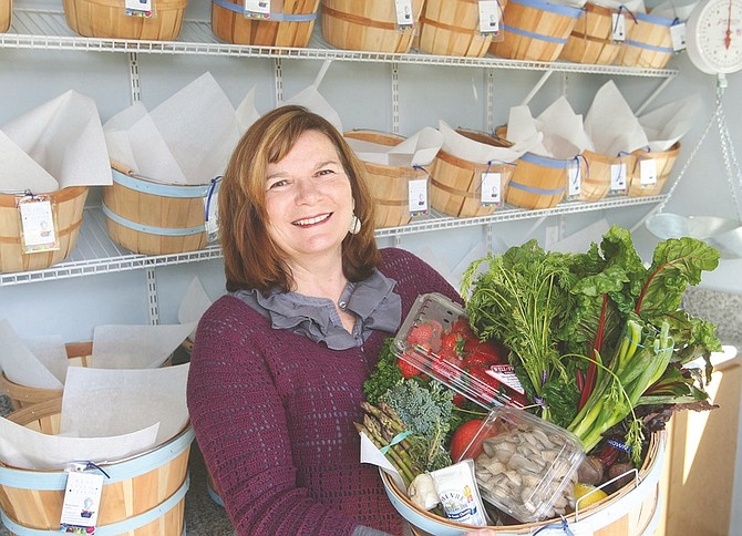 Jim Grant / Nevada AppealKerrie Laack, owner of Blue Basket Organics, displays one of the organic food baskets that she offers to her customers. Laack also teaches English at Carson High School.