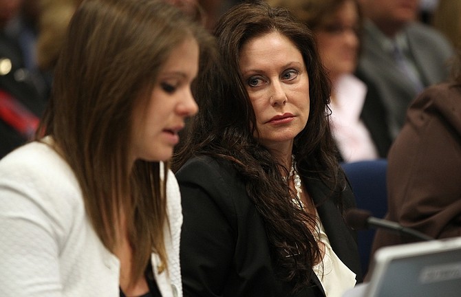Bridgette Zunino-Denison, mother of Brianna Denison, right, listens as her niece Ashley Zunino testifies on a bill that would require anyone arrested on a felony charge or sexual assault to give a DNA sample. Family members of crime victims told lawmakers the measure could save lives during a hearing Wednesday, April 13, 2011, at the Legislature in Carson City, Nev. (AP Photo/Cathleen Allison)