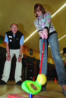 Jim Grant/Nevada AppealNels Ahnlund, left, a lead coach with The First Tee of Northern Nevada watches Alex Lamp, a fourth grade student at Bordewich-Bray Elementary school chip off a mat in the school&#039;s gym on Tuesday.