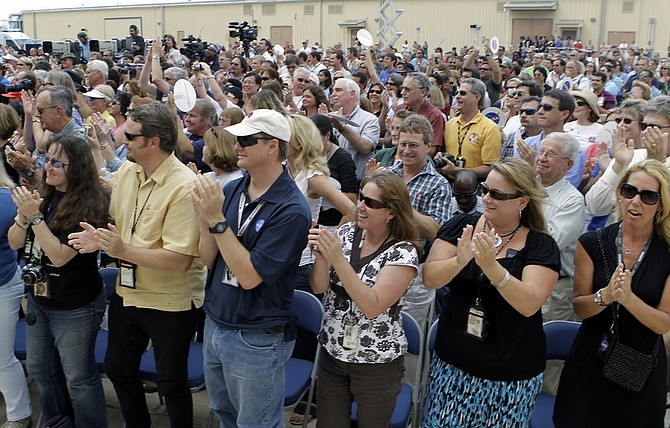 NASA workers and guests applaud and cheer after NASA Administrator Charles Bolden announced Tuesday, April 12, 2011, that after it&#039;s final mission, space shuttle Atlantis will go to the Kennedy Space Center, in Cape Canaveral, Fla.   (AP Photo/John Raoux)