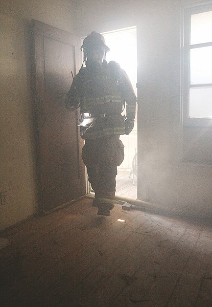 Shannon Litz/Nevada AppealA firefighter enters the abandoned house at 314 E. Telegraph St. during training on Thursday afternoon.