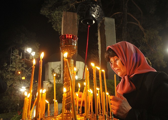 Woman lights candles to honor the memory of the victims of the Chernobyl disaster in Kiev, Ukraine, early Tuesday, April 26, 2011. Ukraine marked the 25th anniversary since the Chernobyl power station exploded in the world&#039;s worst nuclear accident, endangering hundreds of thousands of lives and contaminating pristine forests and farmland. (AP Photo/Sergei Chuzavkov)