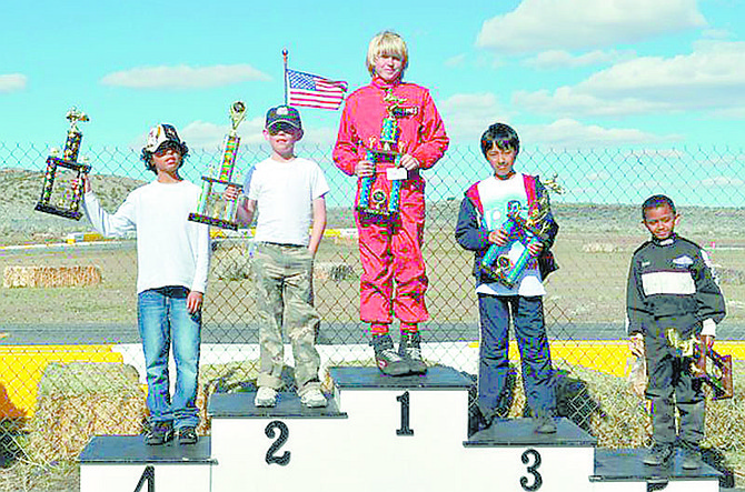 CourtesyRichard Stock, center in red, won the 16-lap Junior One main event go-kart race at Desert Park Raceway near Stead on April 10.