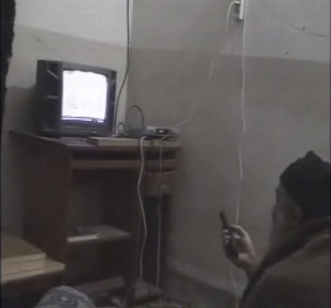 In this undated image taken from video provided by the U.S. Department of Defense, a man who the American government says is Osama bin Laden watches television in a video released on Saturday, May 7, 2011. The videos show bin Laden watching himself on television and rehearsing for terrorist videos. (AP Photo/Department of Defense)
