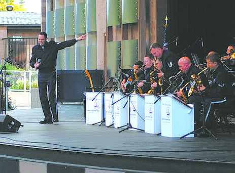 CourtesyStaff Sgt. Geoff Fisher, vocalist for The Commanders Jazz Ensemble, points to the instrumentalists in the band, which iis part of the Air Force Band of the Golden West.